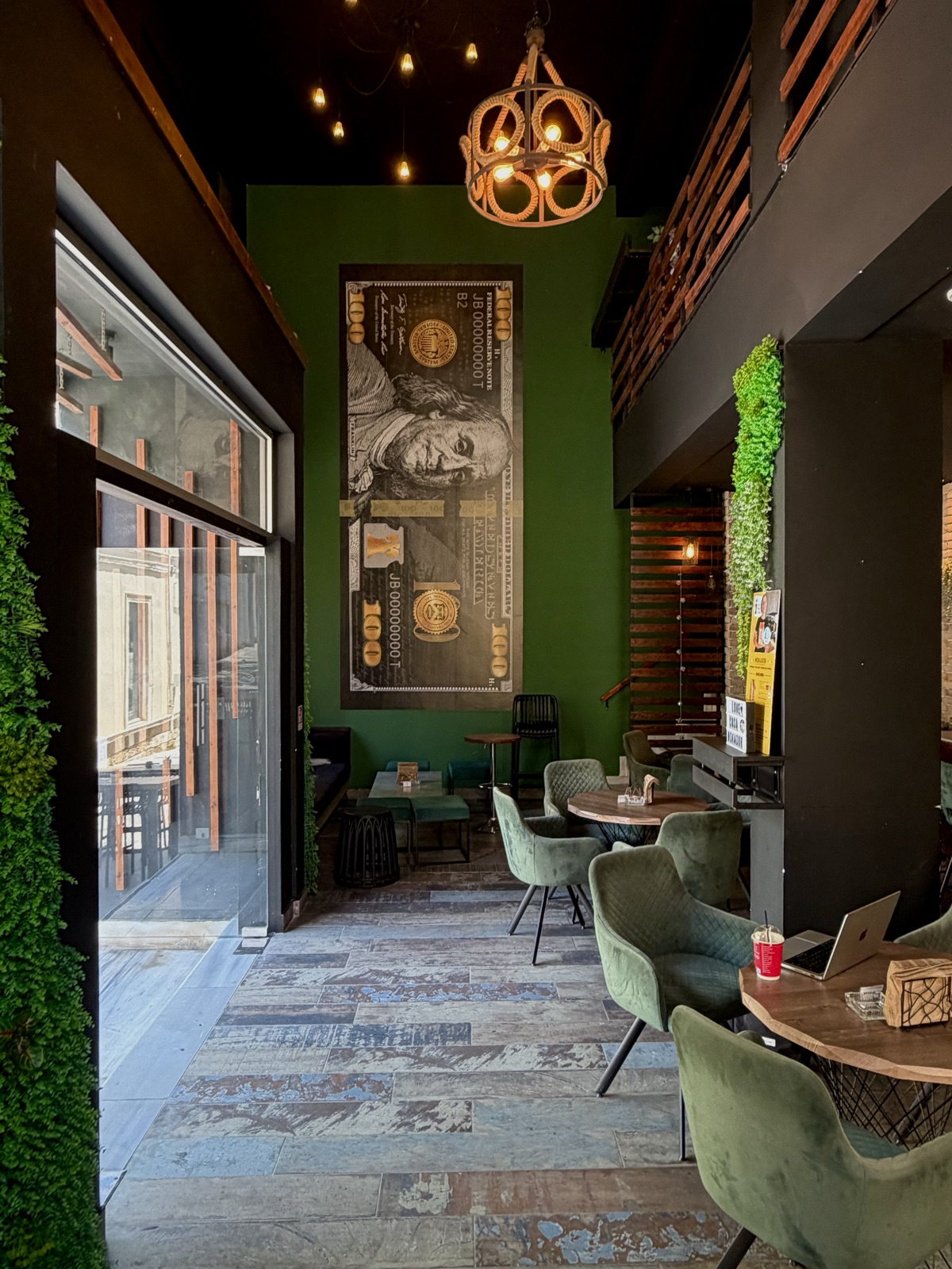 Lounge corner — green velvet chairs by the window
